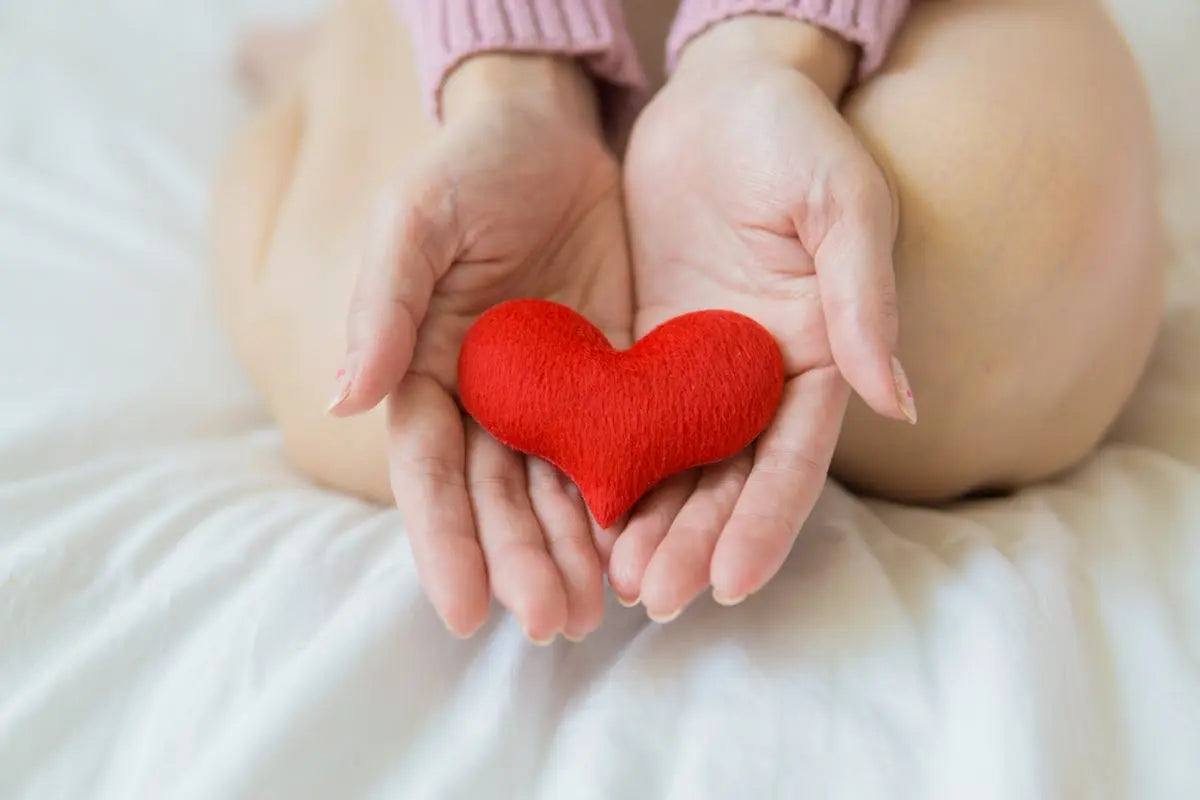 Hands holding a red heart
