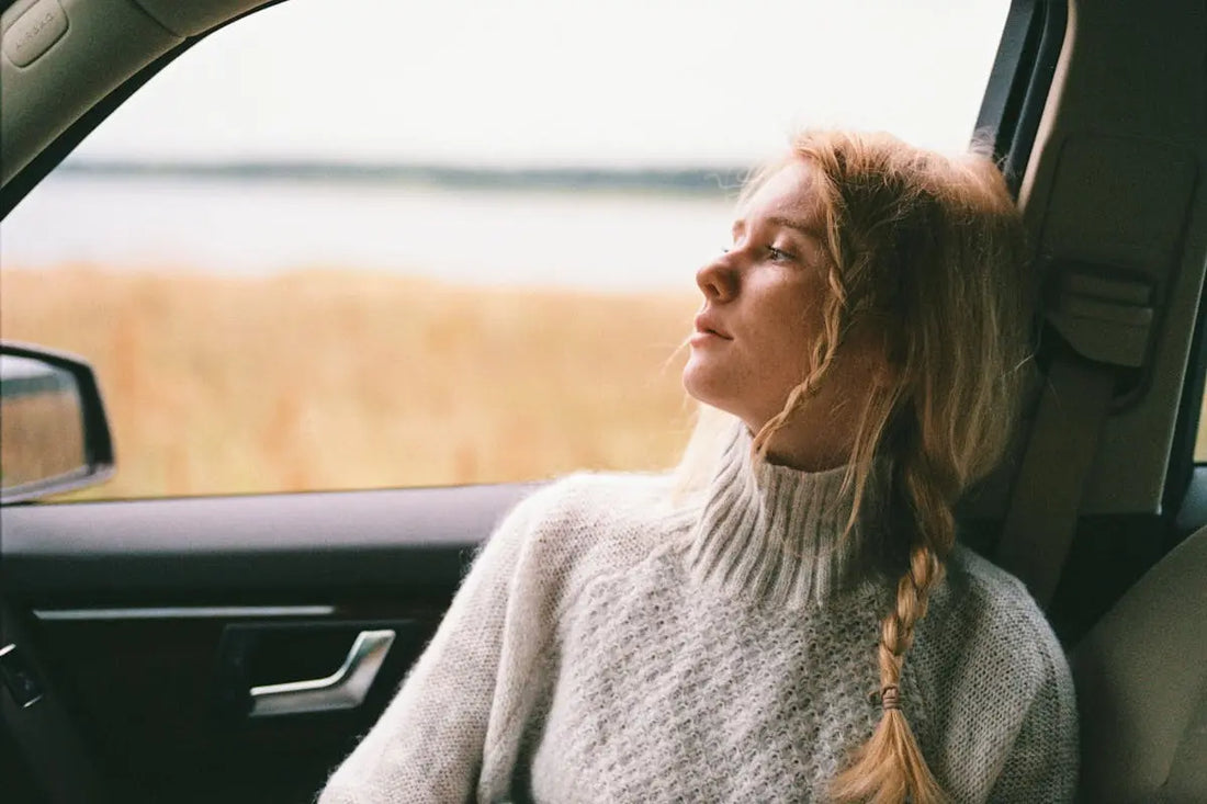 Woman relaxing in car by countryside
